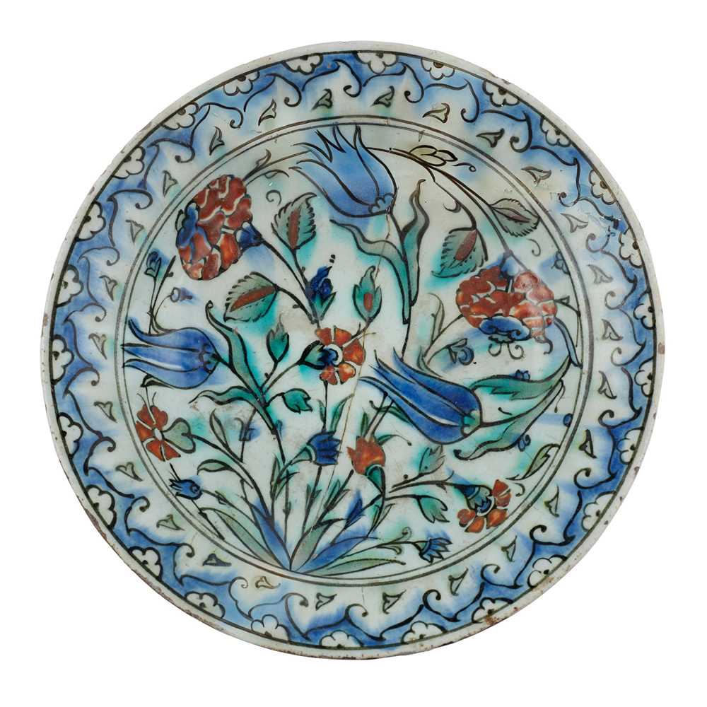 AN IZNIK POTTERY DISH WITH TULIPS, CARNATIONS