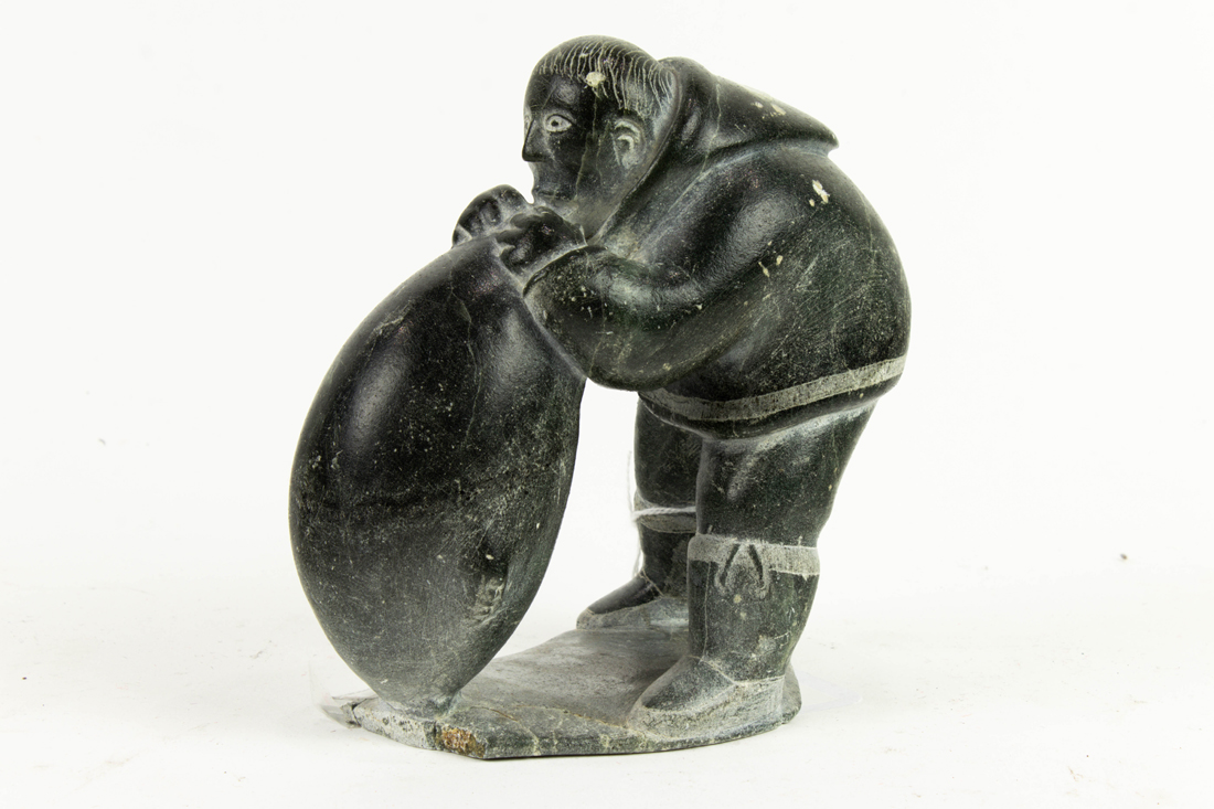 INUIT STONE CARVING OF A MAN AND SEAL