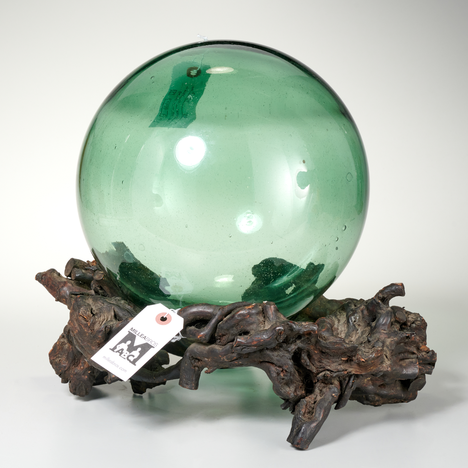 GREEN GLASS WITCH BALL ON TREE-ROOT