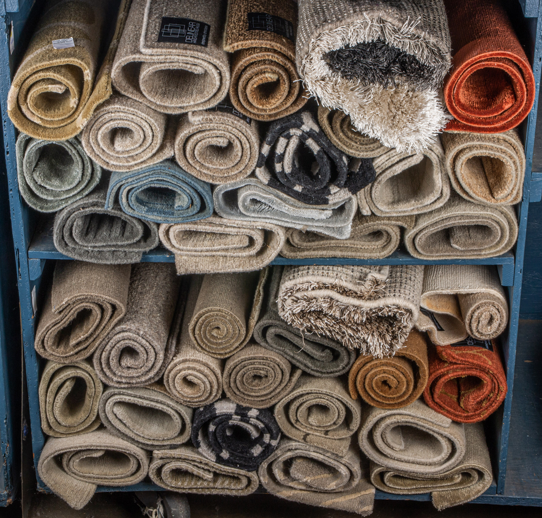 TWO SHELVES OF SMALL HAND KNOTTED