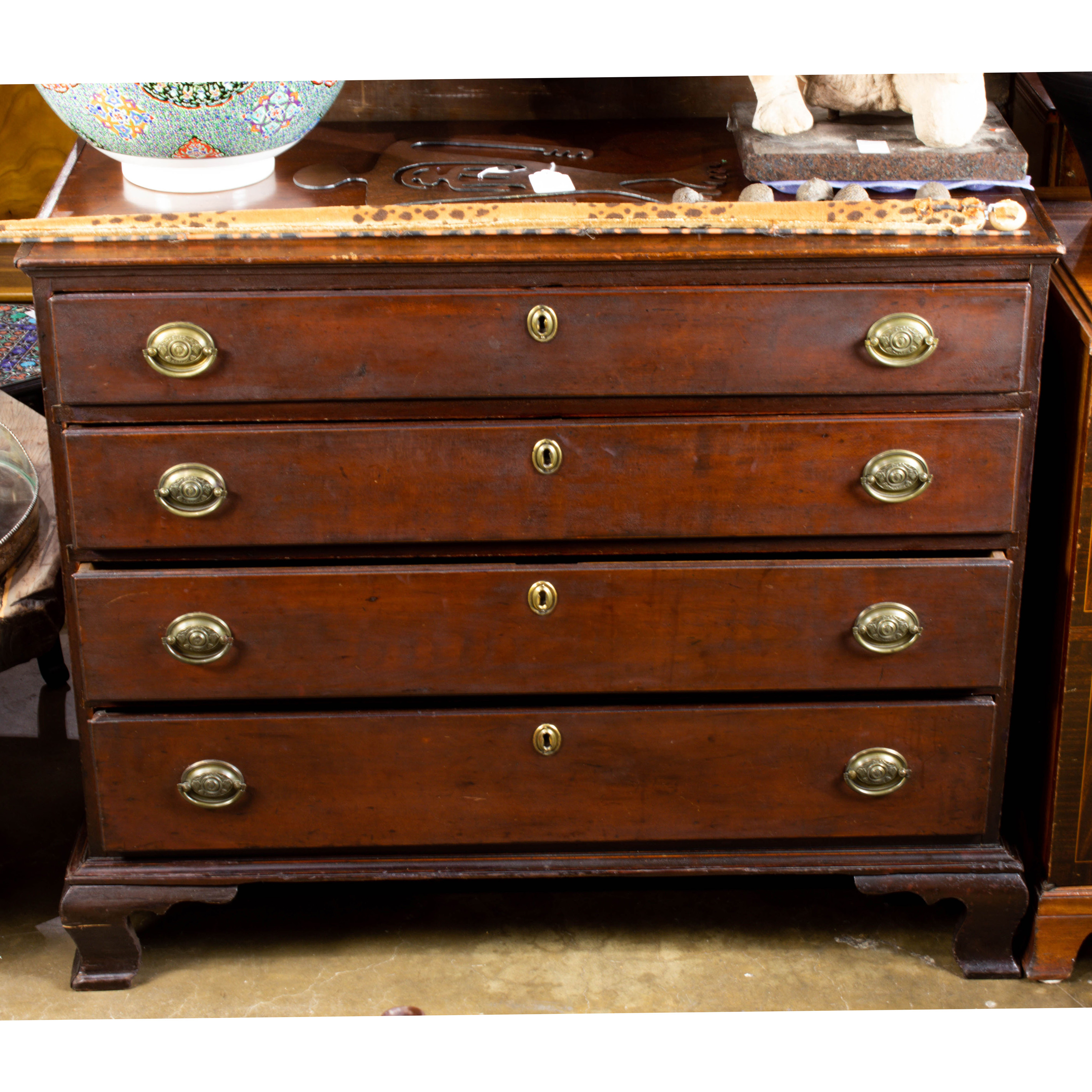 A CHIPPENDALE CHERRY CHEST OF DRAWERS