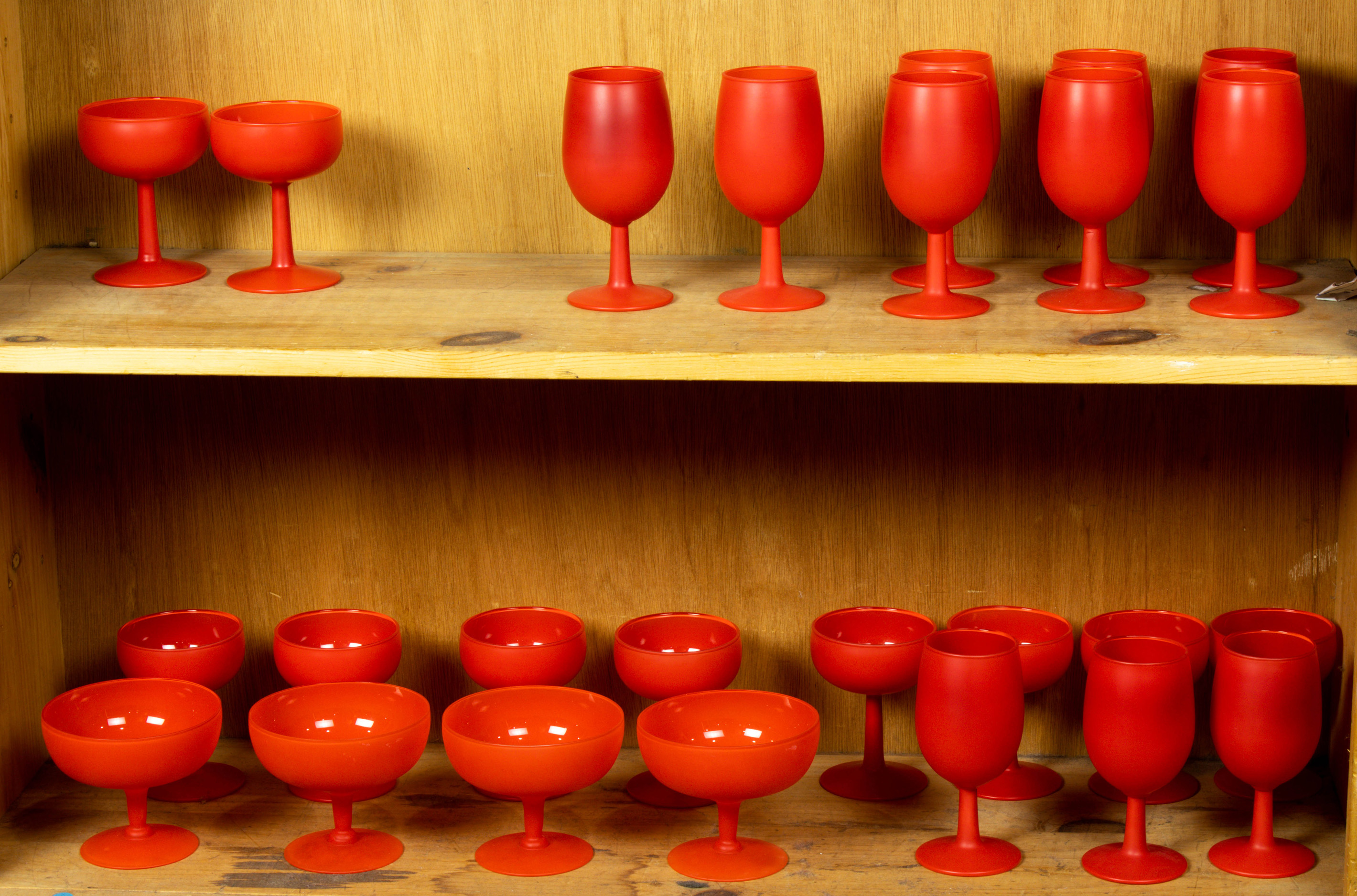 TWO SHELVES OF ART GLASS STEMWARE, INCLUDING