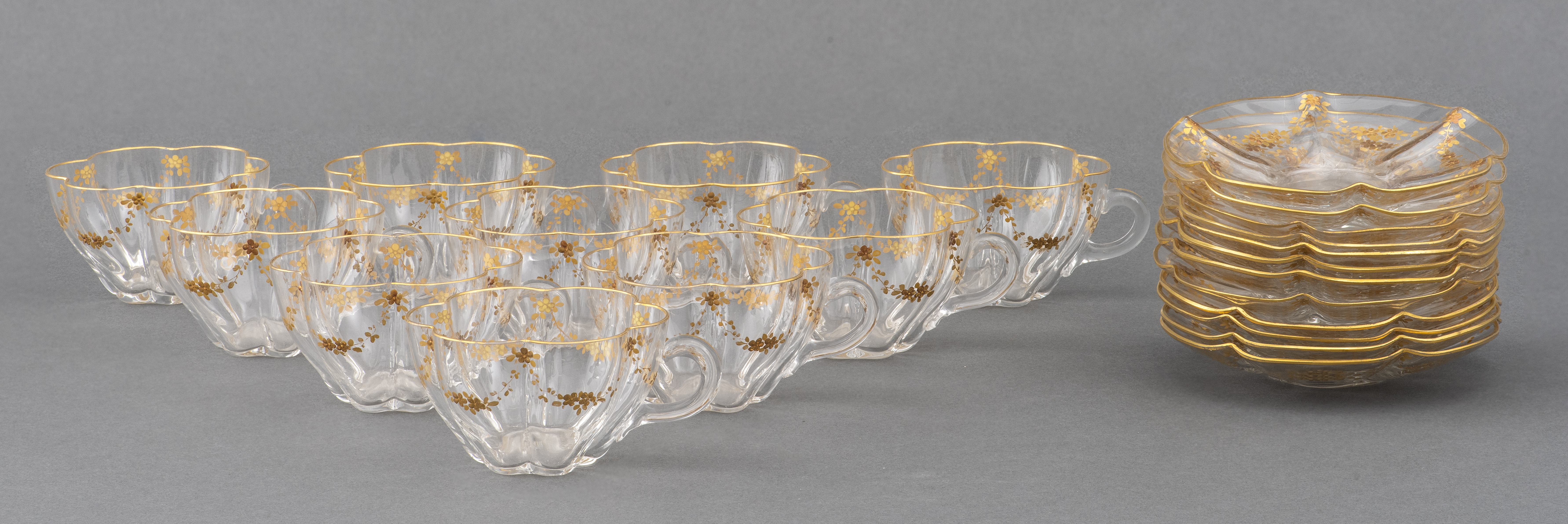 GILT GLASS TEACUPS AND SAUCERS  2d27c8