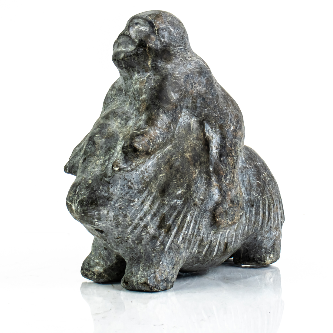 AN INUIT BASALT FIGURE OF MAN RIDING 2d2f67