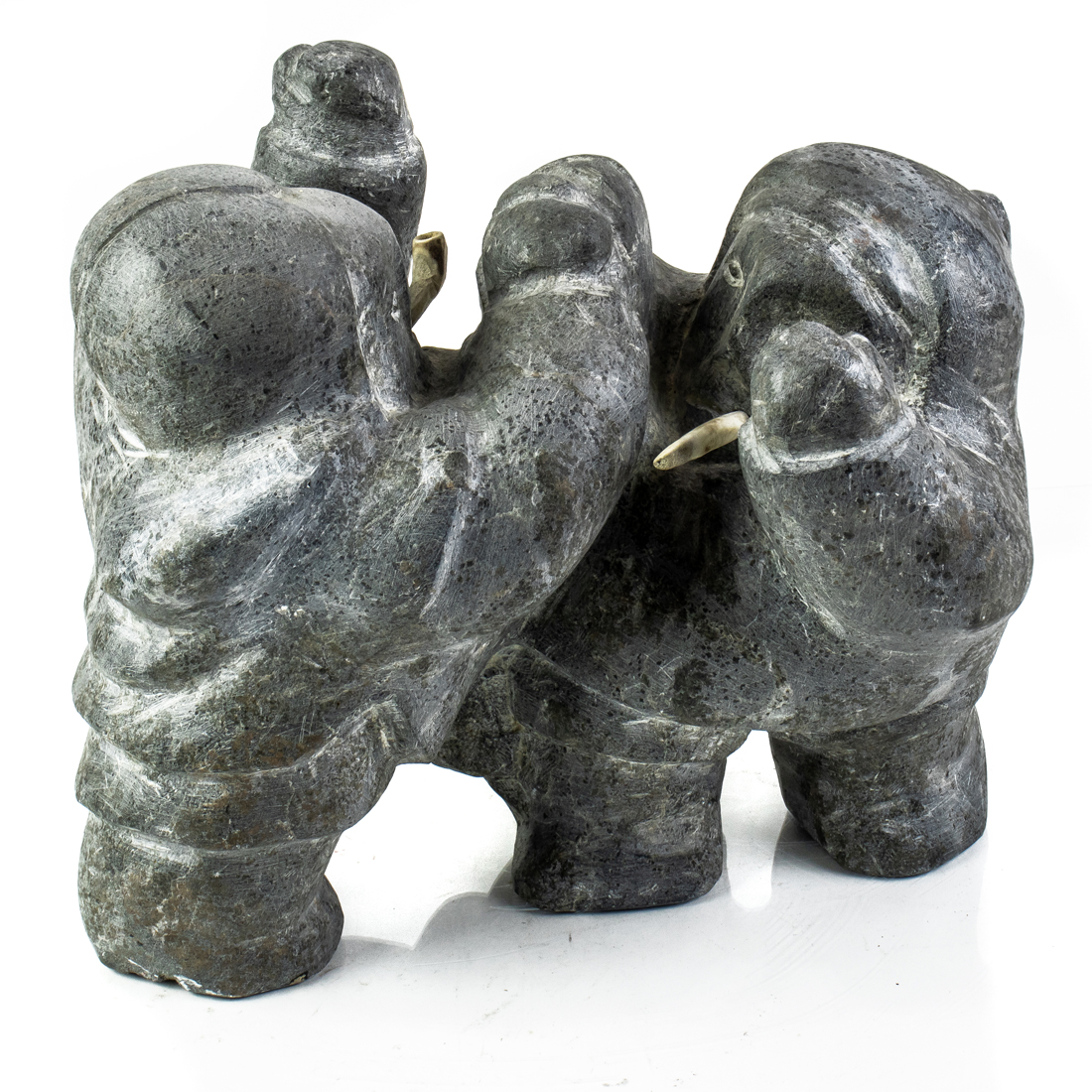 AN INUIT BASALT GROUP OF TWO ESKIMOS