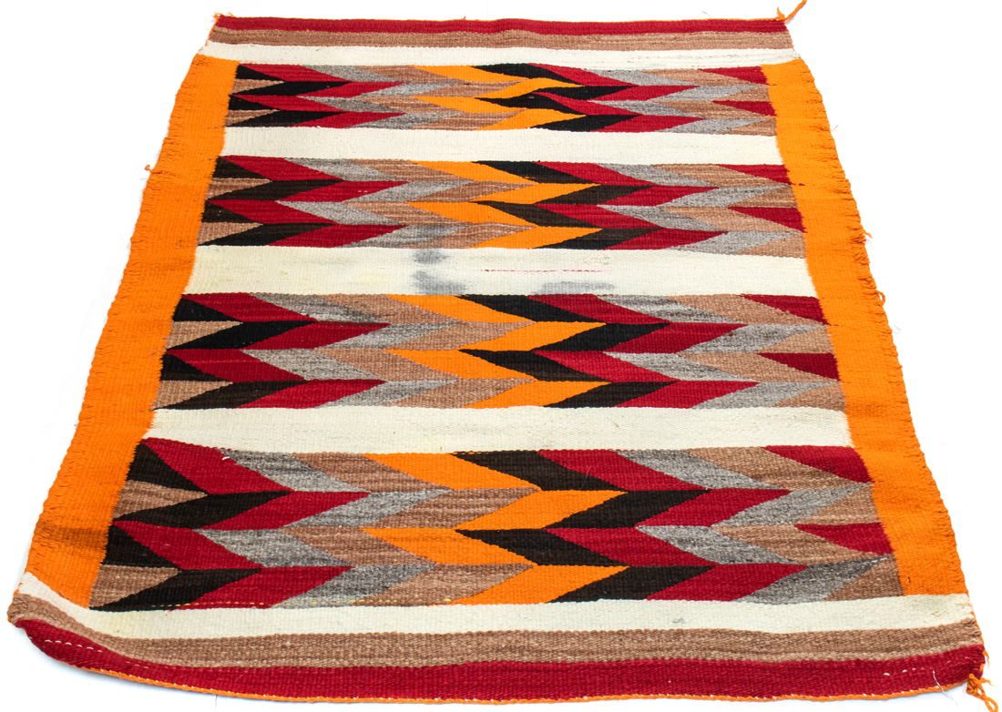 A NAVAJO WEARING BLANKET WITH ORANGE