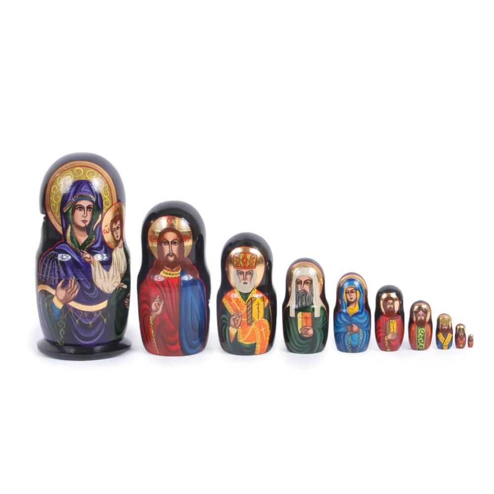 NINE RUSSIAN NESTING DOLLS WITH HAND