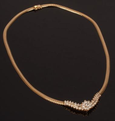 A diamond and 14k gold necklace centred