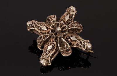 An Eastern white metal brooch of