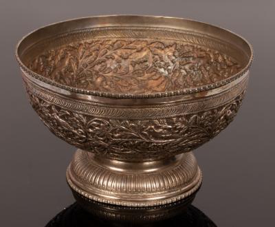 An Indian white metal bowl of circular