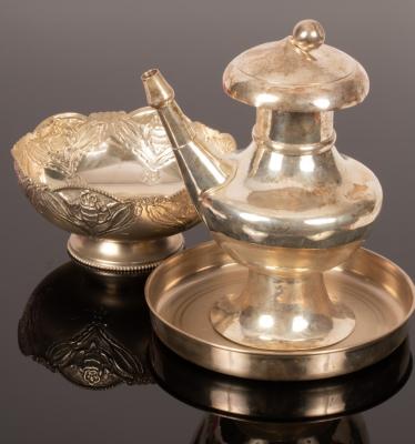 An Indian white metal coffee pot,