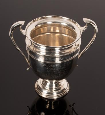 A two-handled pedestal silver prize