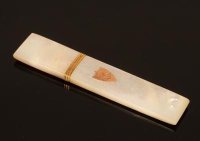 A mother-of-pearl gold mounted needle