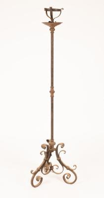 A wrought iron floor standing pricket