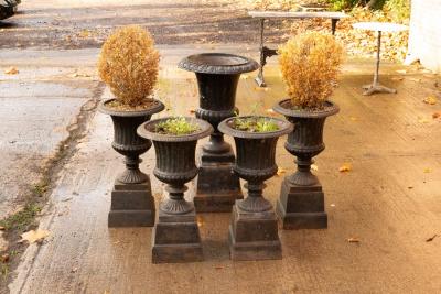 Four cast iron campana shaped vases 2db1f4