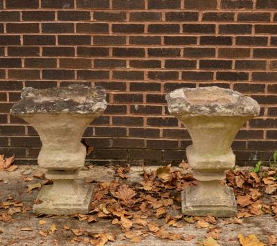 A pair of weathered stone garden vases,