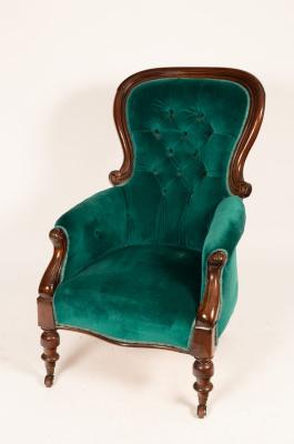 A mahogany armchair with deep button