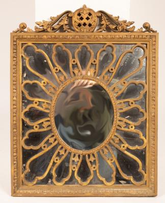 A giltwood wall mirror with scrolling