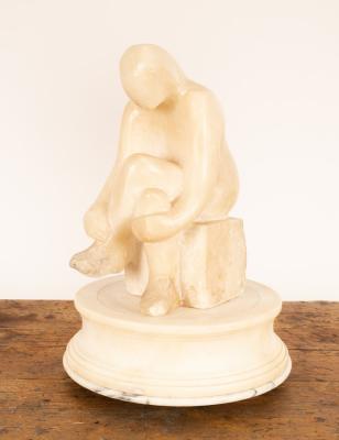 An alabaster figure of a seated figure