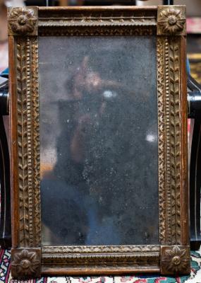 A gilt framed wall mirror with rosette