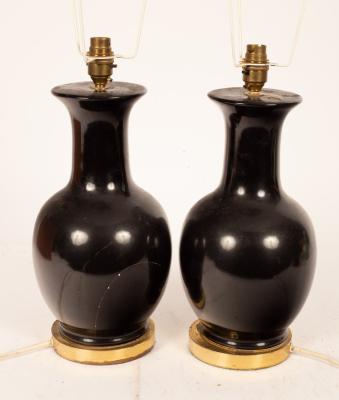 A pair of ebonised vase-shaped