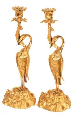 A pair of figured ormolu candlesticks,
