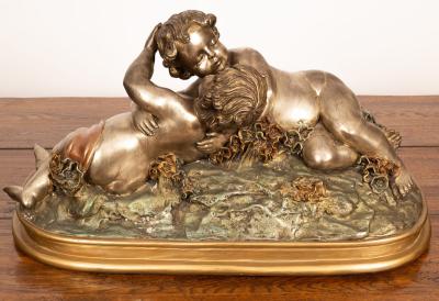 A patinated metal sculpture of embracing