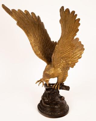 A brass sculpture of an eagle, on a