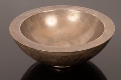 A modern silver bowl with deep rim,
