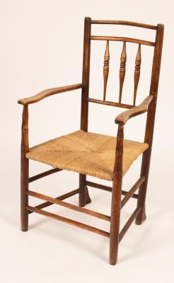 An Arts and Crafts spindle back armchair,