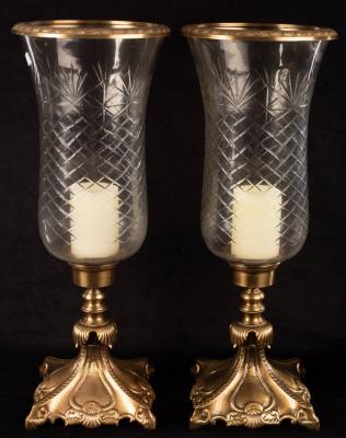 A pair of cut glass and gilt metal candle