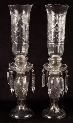 A pair of cut glass candle holders,