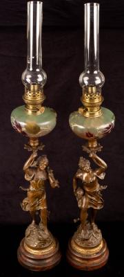 A pair of figural spelter oil lamps,