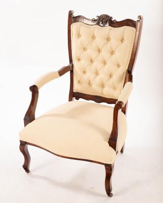 An Edwardian button back open armchair