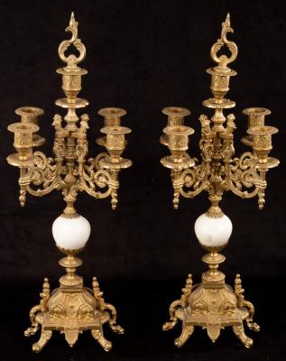 A pair of four-branch brass candelabra,