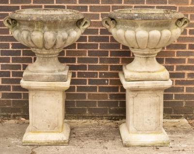 A pair of composition stone urns