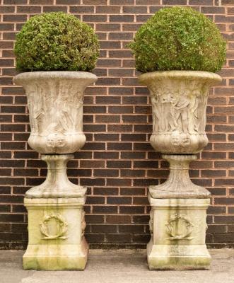 A pair of composition stone urns