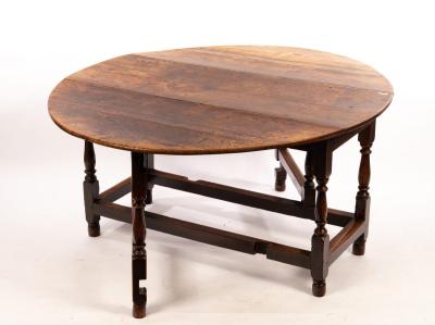 An oval oak gateleg table, the