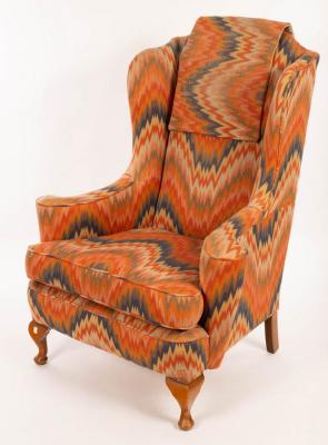 A wing back armchair on dwarf cabriole