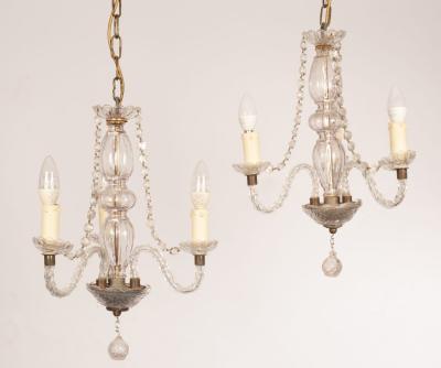 A pair of cut glass three-light chandeliers