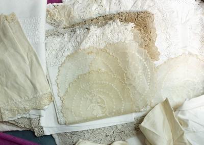 A box of lace table linen and other