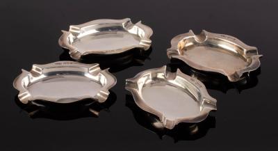 A set of four silver ashtrays,