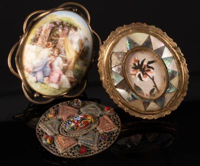 Three brooches, the largest set