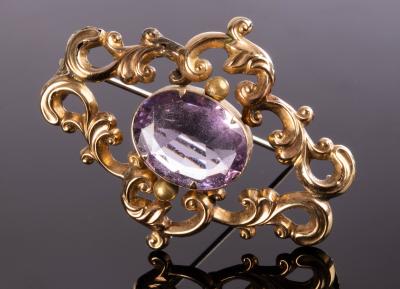 A Victorian brooch centred by an oval