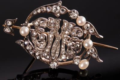 A diamond and pearl brooch of openwork