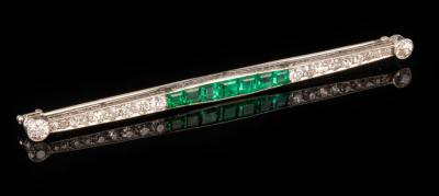 An emerald and diamond bar brooch