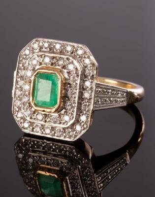 An emerald and diamond cluster ring,