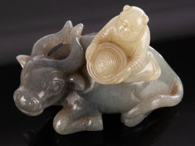 A Chinese grey jade, carved as