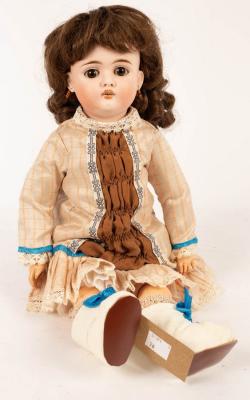 A bisque head doll with white boots