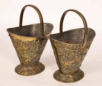 A pair of embossed brass coal buckets